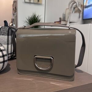 Burberry D-ring crossbody bag in patent toupe leather